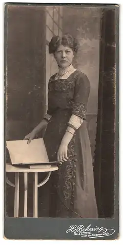 Fotografie H. Behning, Buxtehude, Portrait junge Dame im Kleid mit Buch