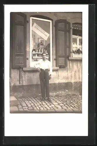 Foto-AK Junger Mann steht vor dem Schaufenster eines Geschäftes