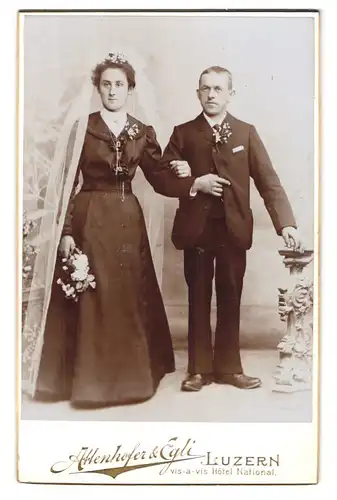Fotografie Attenhofer & Egli, Luzern, Eheleute Laufer am Hochzeitstag im Hochzeitskleid und Anzug