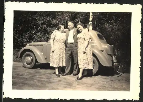 Fotografie Auto Opel, Herr mit Damen im Arm nebst PKW