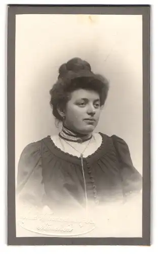 Fotografie Max Wannensperger, München, Frau in hochgeschlossenem Kleid und mit hochgestecktem Haar