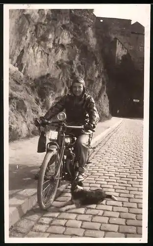 Fotografie Motorrad Stock, junge Frau mit Haube, Lederjacke & Schutzbrille auf Krad, Hund liegt daneben