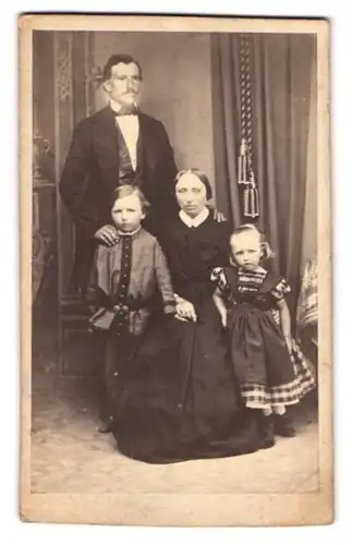 Fotografie L. Feuerrohr, Rinteln, Portrait Familie mit zwei Kindern in Biedermeierkleidung posiert im Atelier