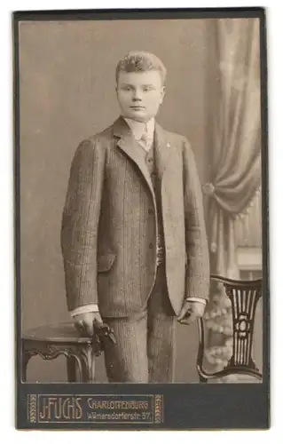 Fotografie J. Fuchs, Berlin-Charlottenburg, Wilmersdorferstrasse 57, Portrait junger Herr im Anzug mit Krawatte