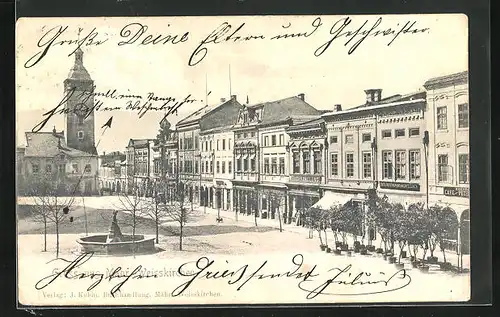 AK Mähr.-Weisskirchen, Strassenpartie mit Geschäften und Brunnen