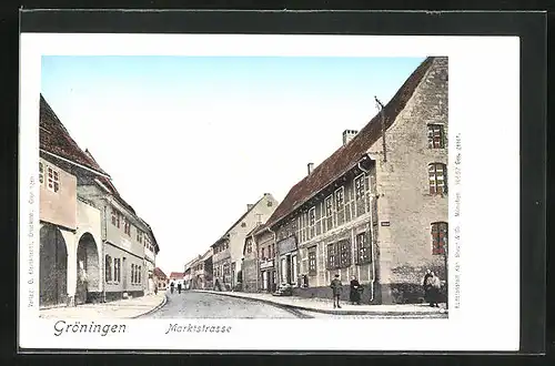 Goldfenster-AK Gröningen, Marktstrasse mit leuchtenden Fenstern