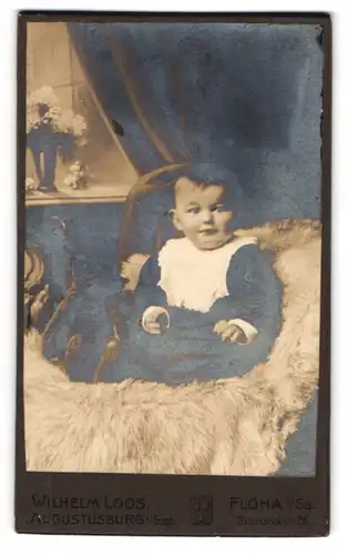 Fotografie Wilhelm Loose, Augustusburg i. Erzg., Marienbergerstr. 25, Portrait niedliches Baby auf einem Fell