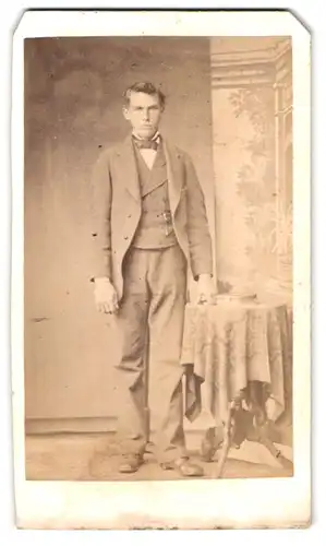 Fotografie T. Zacharias, Husum, Neustadt 192, Portrait grosser Mann im Anzug mit Fliege posiert im Atelier