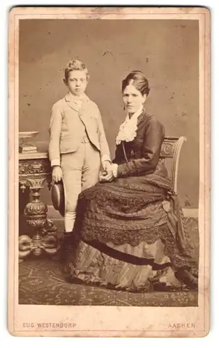 Fotografie Eug. Westendorp, Aachen, Damengraben 19, Portrait junge Dame im Kleid mit einem Jungen