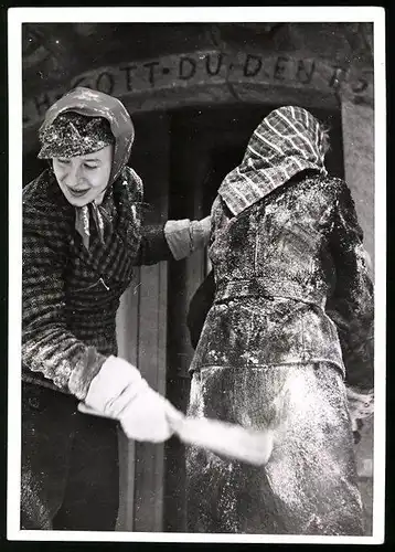 Fotografie Gerhard Riebicke, Berlin, Dame wird mit Bürste vom Pulverschnee befreit