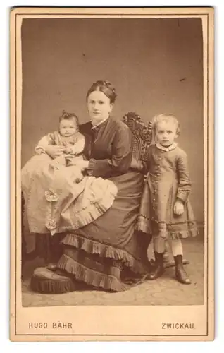 Fotografie Hugo Bähr, Zwickau, Kaiser Wilhelmplatz 423, Frau im schwarzen Kleid mit ihren zwei Kindern, Mutterglück