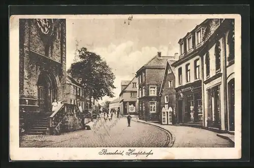 AK Burscheid, Hauptstrasse mit Kirche und Geschäften