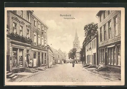 AK Burscheid, Hauptstrasse mit Geschäften und Kirchblick