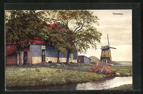Künstler-AK Photochromie Nr. 2955: Volendamm, Wohnhaus mit Windmühle im Hintergrund