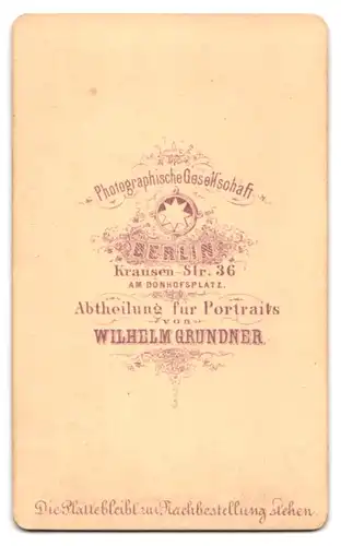 Fotografie Wilhelm Grundner, Berlin, Krausen-Str. 36, Portrait junger Mann im Anzug sitzt am Sekretär