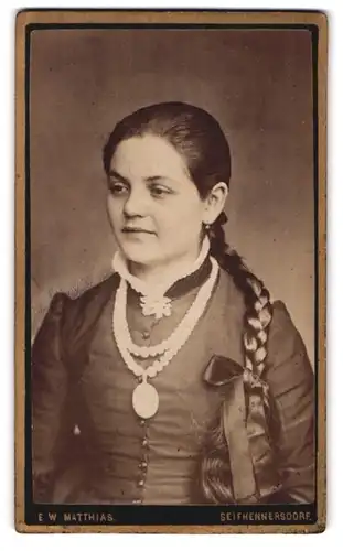 Fotografie E. W. Matthias, Seifhennersdorf, Portrait junge Dame im Kleid mit Amulett