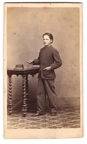 Fotografie unbekannter Fotograf und Ort, Portrait kleiner Knabe im karierten Anzug mit Buch in der Hand