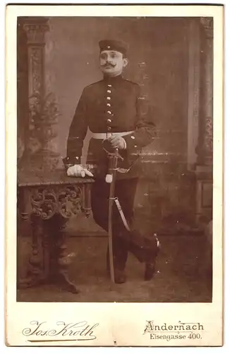 Fotografie Jos. Kroth, Andernach, Eisengasse 400, Portrait Soldat in Uniform mit Säbel und Krätzchen