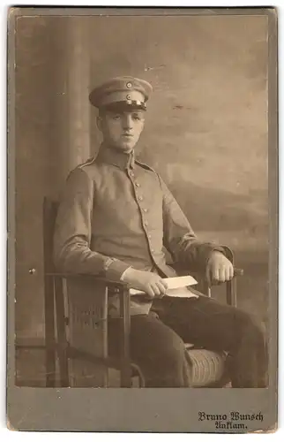 Fotografie Bruno Wunsch, Anklam, junger Soldat in Uniform sitzend im Sessel