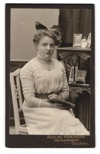 Fotografie Adolph Hartmann, Dessau, Portrait junge Dame Käte Senne im Jugendstilkleid mit Haarschleife, 1912