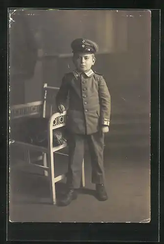 Foto-AK Kleiner Soldat in Uniform mit Schirmmütze, Kinder Kriegspropaganda