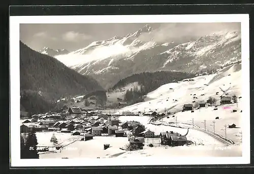 AK St. Anton, Fernblick auf die verschneite Ortschaft