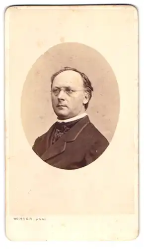 Fotografie M. L. Winter, Prag, Portrait stattlicher Herr mit Brille im eleganten Jackett