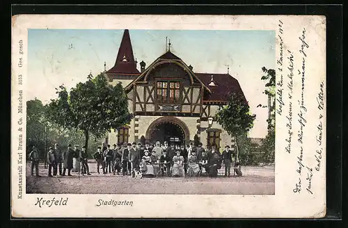 Goldfenster-AK Krefeld, Gasthaus mit leuchtenden Fenstern im Stadtgarten