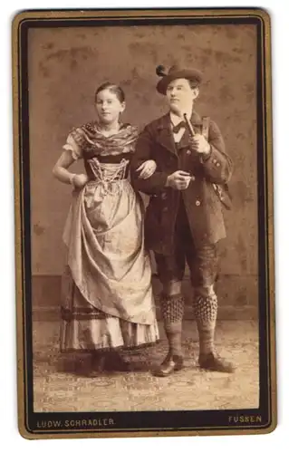 Fotografie Ludw. Schradler, Füssen, Portrait junges Paar in bayrischer Tracht mit Dirndl und Lederhosen