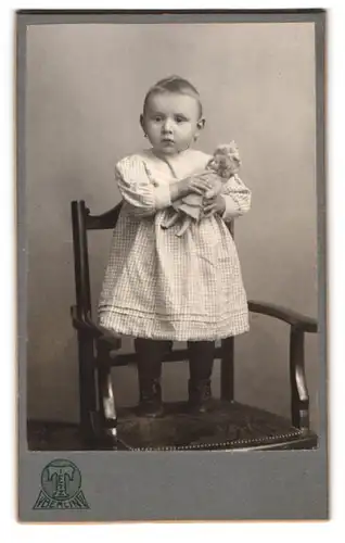 Fotografie Hermann Tietz, Berlin, Alexanderplatz, Portrait niedliches Mädchen im karierten Kleidchen mit Puppe im Arm