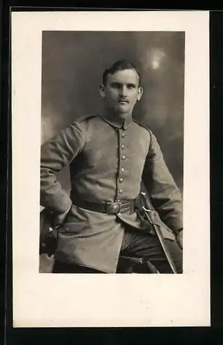 AK Traunstein, junger Soldat mit Schirmmütze in der Hand und seinem Säbel, Uniformfoto