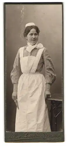 Fotografie Lemie, Berlin, Bülowstr. 8, Portrait junge Dienstmagd in Dienstuniform mit Schürze und Haube