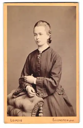 Fotografie Eulenstein, Leipzig, Tauchaer Str. 29, hübsche junge Frau im dunklen Kleid mit Kruzifix und Ohrringen