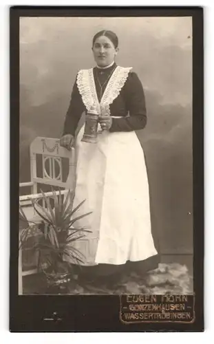Fotografie Eugen Hohn, Gunzenhausen, Portrait junge Schankfrau mit Schürze und Bierkrug / Bierhumpen