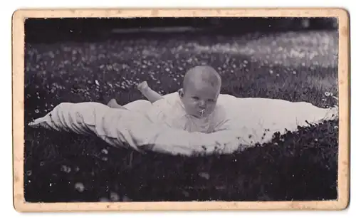 Fotografie unbekannter Fotograf und Ort, Süsses Kleinkind im Hemd liegt auf Decke