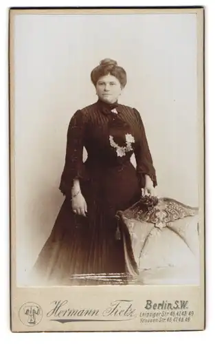 Fotografie Hermann Tietz, Berlin, Leipziger Strasse 46-49, Dame mit Hochsteckfrisur im schwarzen Kleid