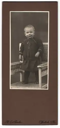 Fotografie H. E. Theiler, Offenbach a. M., Frankfurterstrasse 39, Kleinkind steht auf Stuhl