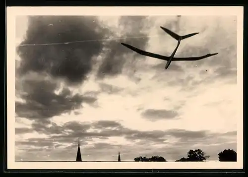 Fotografie Otto Dowe, Berlin, Segelflug, Segelflugzeug-Modell am wolkenverhangenen Himmel über Berlin