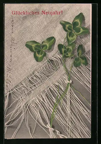 Künstler-AK M. Munk Nr. 164: Neujahrsgrüsse mit in Stoff eingewicktelten Kleeblättern
