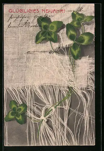 Künstler-AK M. Munk Nr. 164: Neujahrsgrüsse mit in Stoff eingewicktelten Kleeblättern
