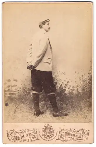 Fotografie Dupont, Bruxelles, Rue Neuve 109, Portrait Herr im Anzug mit Knickerbockern im Rückenportrait