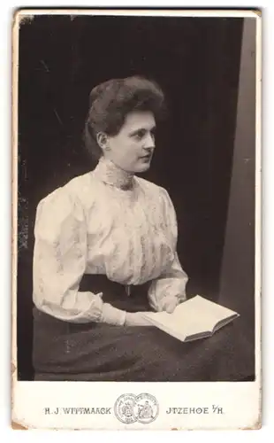 Fotografie H. J. Wittmaack, Itzehoe i. H., Bergstr. 1a, Portrait brünette Schönheit hält ein Buch in den Händen