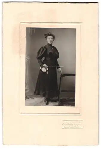 Fotografie Atelier Meiler, Kaufbeuren, Junge Dame im schwarzen Rüschenkleid mit Puffärmeln und Hochsteckfrisur