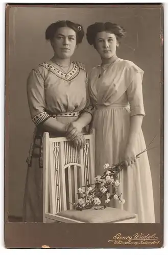 Fotografie Georg Wedel, Würzburg, Kaiserstr. 9, Zwei junge Damen in modischen Kleidern mit Blumen