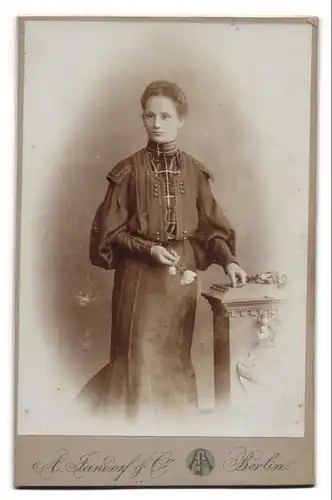 Fotografie A. Jandorf & Co., Berlin, Junge Dame in verziertem Kleid hält eine Rose