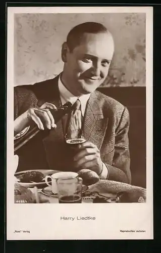 AK Schauspieler Harry Liedtke trinkt ein Bier bei Tisch