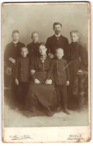 Fotografie Max Kühn, Kiel, Jägersberg 6, Junger Herr und Dame mit fünf Kindern in zeitgenössischer Kleidung