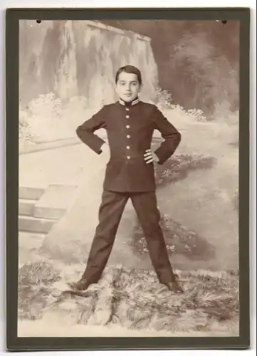 Fotografie unbekannter Fotograf und Ort, junger Knabe als K.u.K. Kadett in Gardeuniform posiert mit gesprietzten Beinen