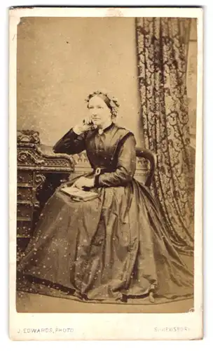 Fotografie J. Edwards, Shrewsbury, Lady im Bidermeierkleid in Denkerpose mit offenen Buch