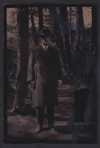 Fotografie Ferrotypie Herr im Trenchcoat mit Melone und zwei Finger Bart posiert im Wald